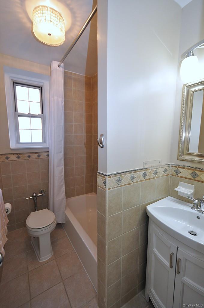 253 Garth Road, Unit 1T Scarsdale, NY 10583 - Photo 25 of 45 a bathroom with a sink a toilet and shower