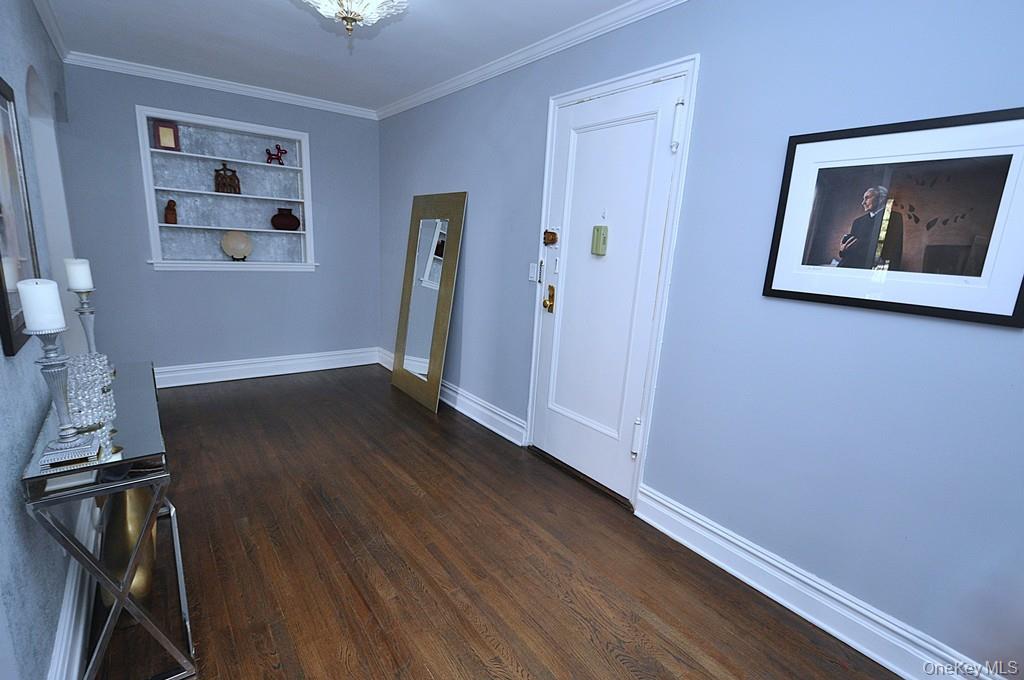 253 Garth Road, Unit 1T Scarsdale, NY 10583 - Photo 26 of 45 a view of an empty room with wooden floor and a window