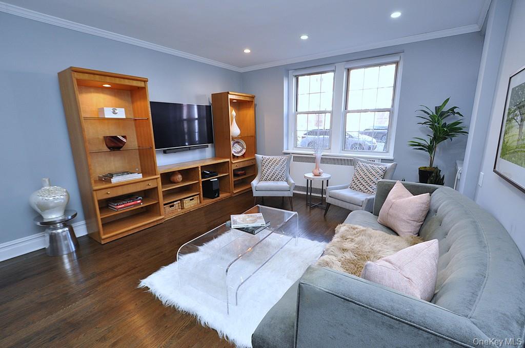 253 Garth Road, Unit 1T Scarsdale, NY 10583 - Photo 5 of 45 a living room with furniture and a flat screen tv