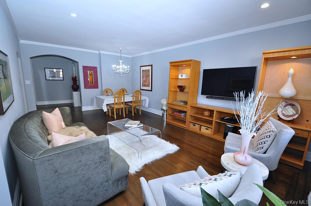 253 Garth Road, Unit 1T Scarsdale, NY 10583 - Photo 6 of 45 a living room with furniture and a flat screen tv