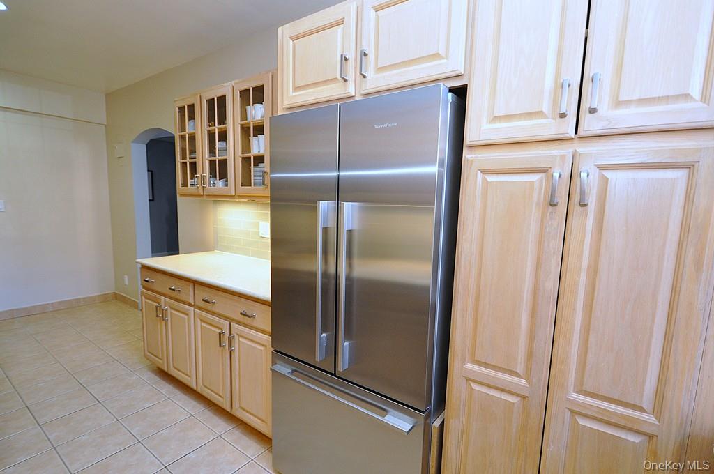 253 Garth Road, Unit 1T Scarsdale, NY 10583 - Photo 10 of 45 a kitchen with stainless steel appliances granite countertop a refrigerator and a stove