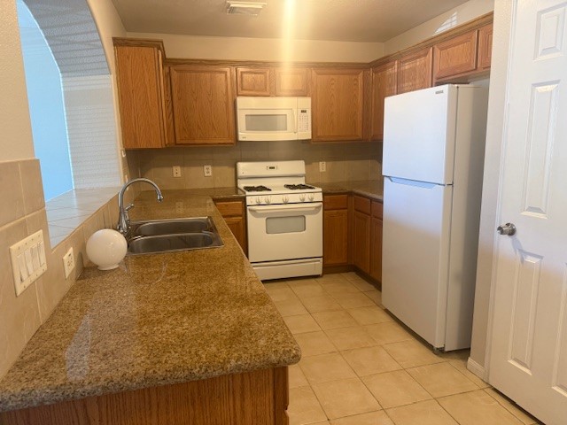 5419 Quail Cove Lane Houston, TX 77053 - Photo 4 of 13 a kitchen with a refrigerator sink and stove