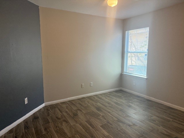 5419 Quail Cove Lane Houston, TX 77053 - Photo 10 of 13 an empty room with wooden floor and windows