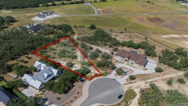 an aerial view of a house with a swimming pool