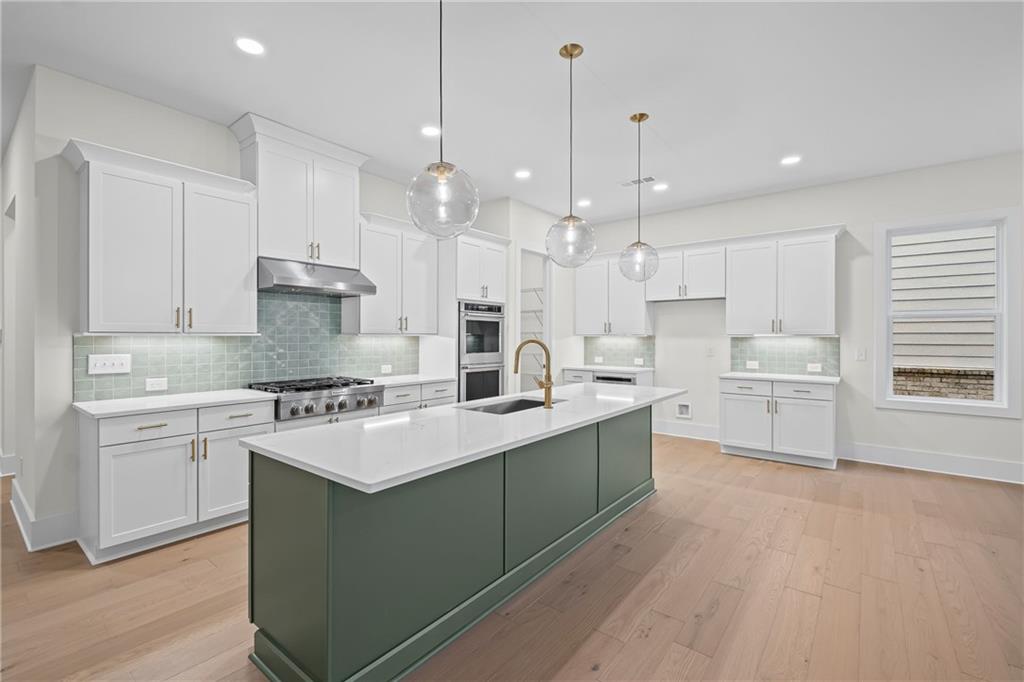 178 Mooney Road Woodstock, GA 30188 - Photo 12 of 42 a kitchen with white cabinets stainless steel appliances and a center island