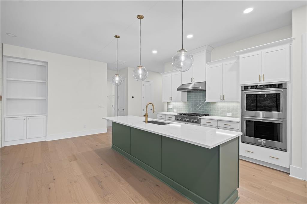 178 Mooney Road Woodstock, GA 30188 - Photo 13 of 42 a large kitchen with kitchen island a sink stainless steel appliances and cabinets
