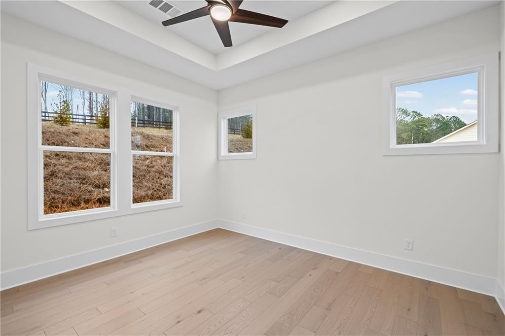 178 Mooney Road Woodstock, GA 30188 - Photo 17 of 42 a view of an empty room with a window and a ceiling fan