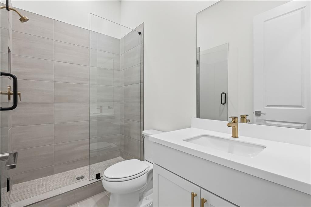 178 Mooney Road Woodstock, GA 30188 - Photo 22 of 42 a bathroom with a sink a toilet and shower