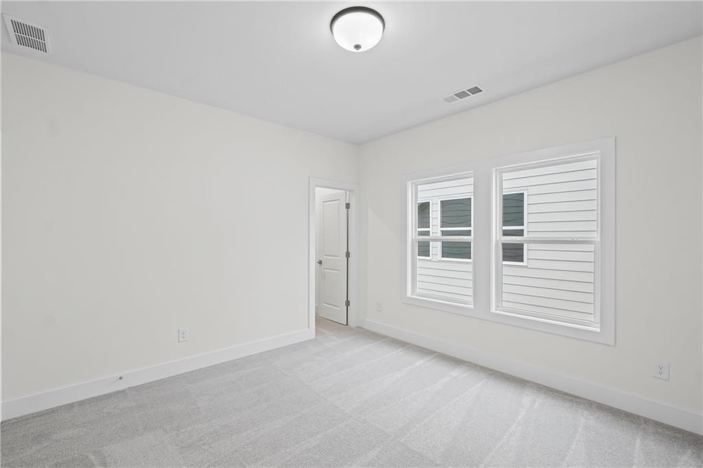 178 Mooney Road Woodstock, GA 30188 - Photo 28 of 42 an empty room with windows