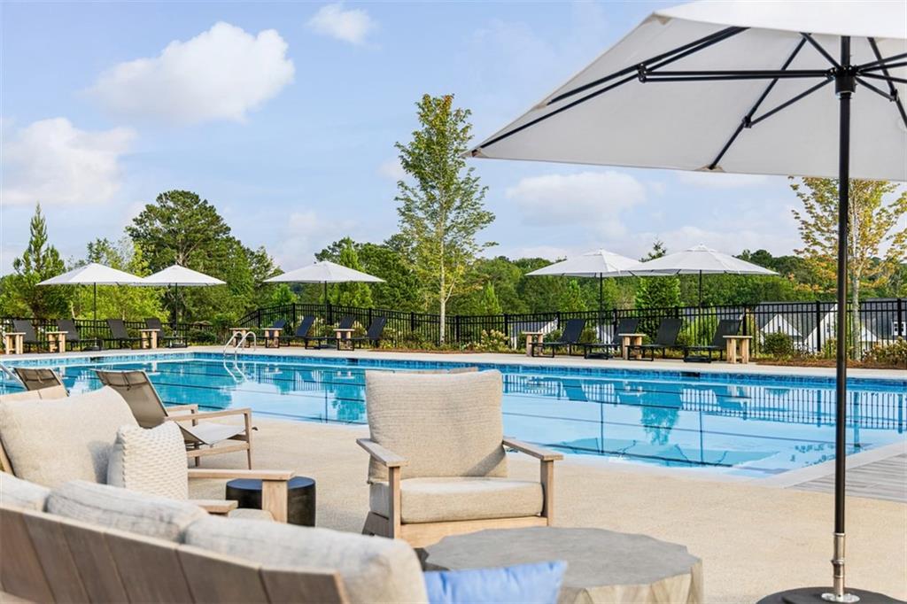 178 Mooney Road Woodstock, GA 30188 - Photo 38 of 42 a view of a roof deck with couches under an umbrella