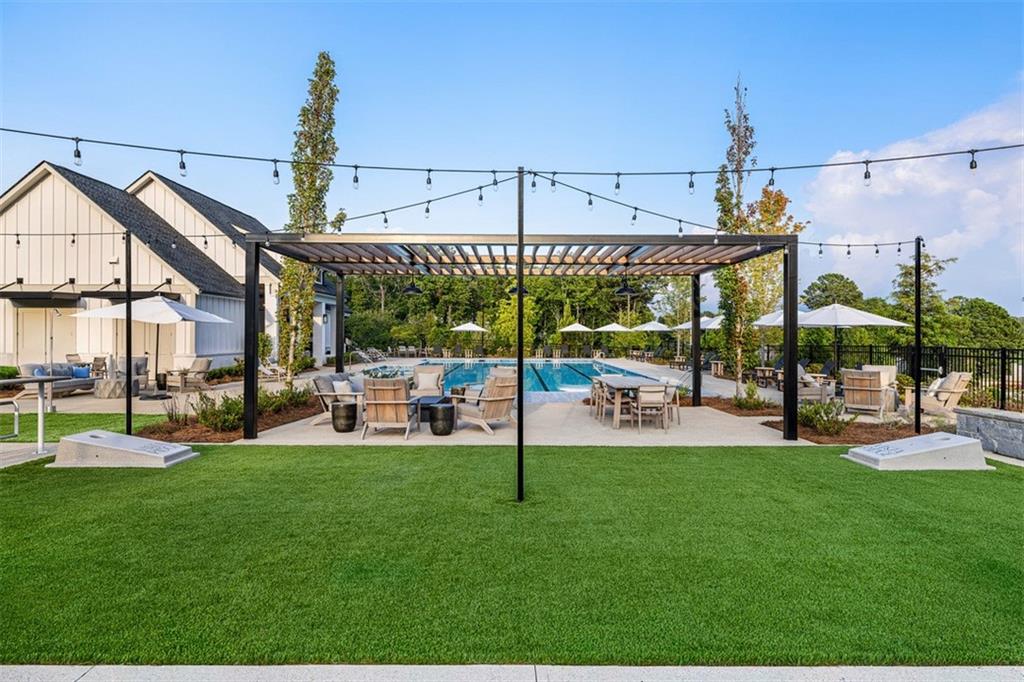 178 Mooney Road Woodstock, GA 30188 - Photo 41 of 42 a view of a swimming pool with a table and chairs