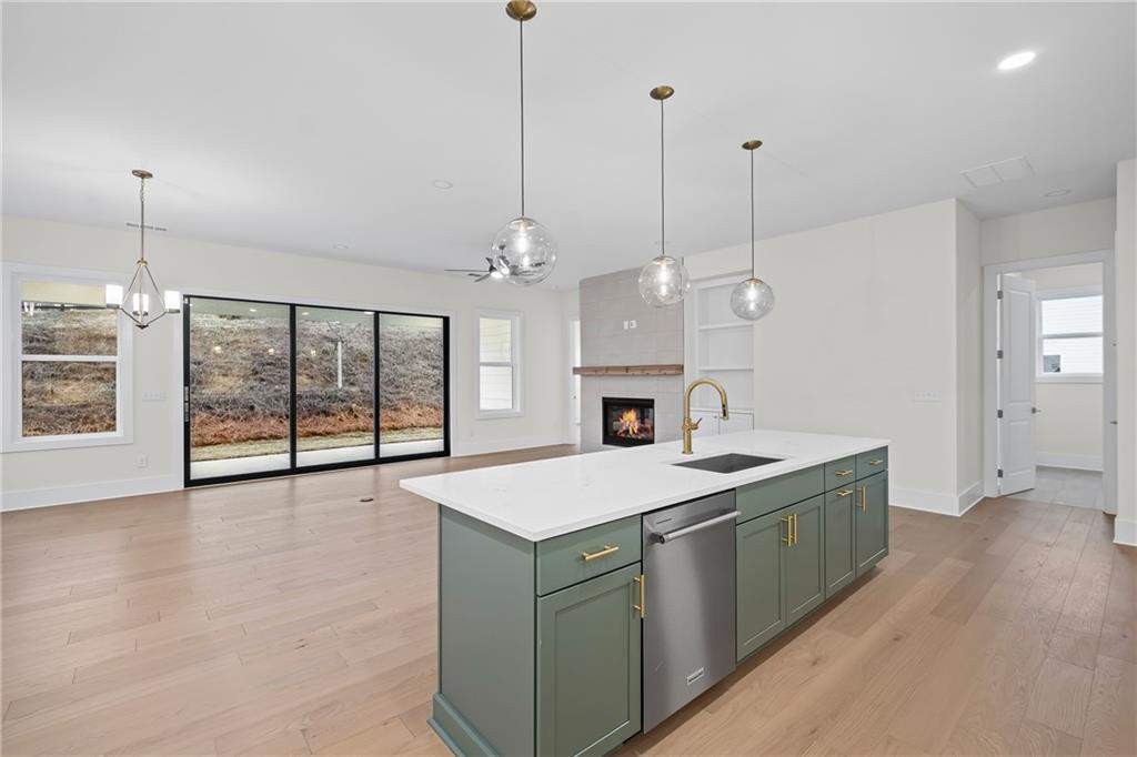 178 Mooney Road Woodstock, GA 30188 - Photo 6 of 42 a large white kitchen with a large window and chandelier