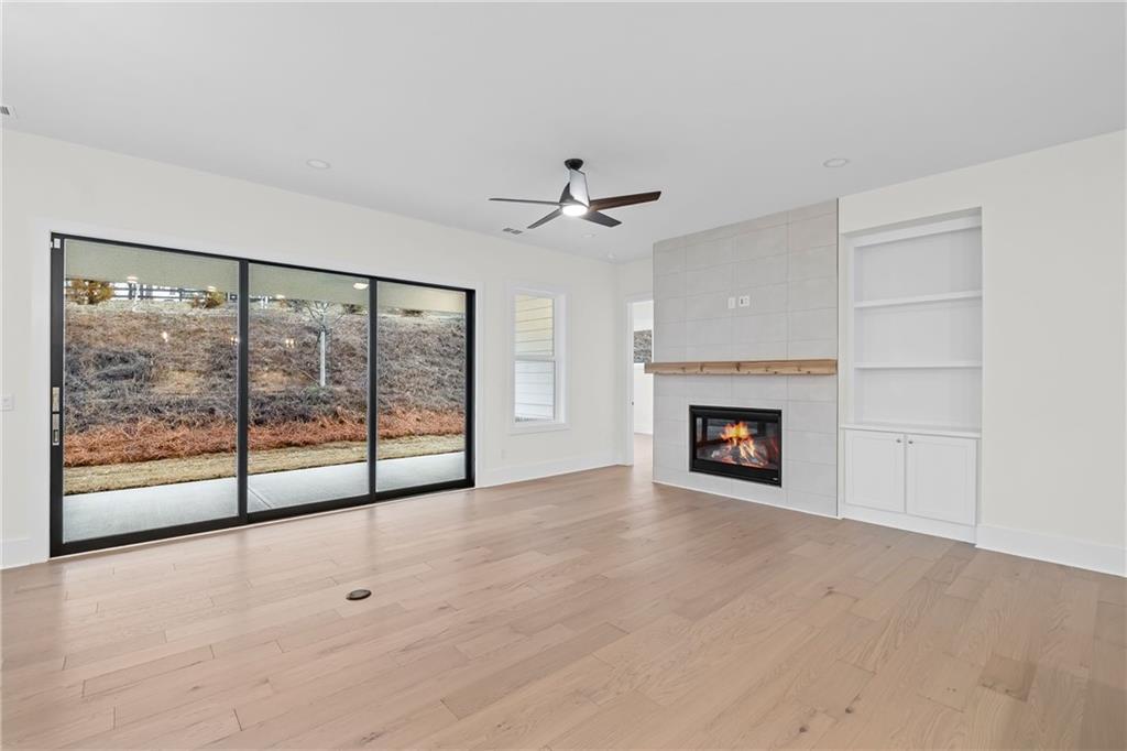178 Mooney Road Woodstock, GA 30188 - Photo 9 of 42 a view of an empty room with a fireplace and a window