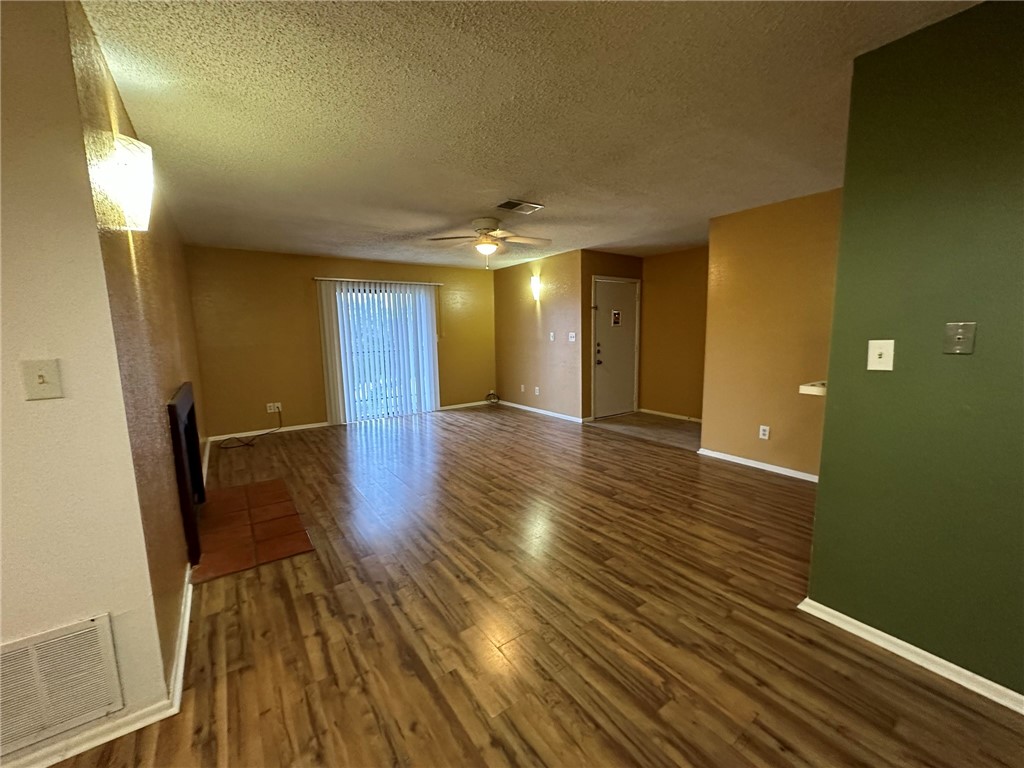 4229 Interstate Highway, Unit 4 Corpus Christi, TX 78410 - Photo 4 of 12 a view of a room with wooden floor and staircase