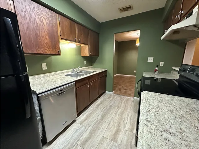 a kitchen with a sink a stove and refrigerator