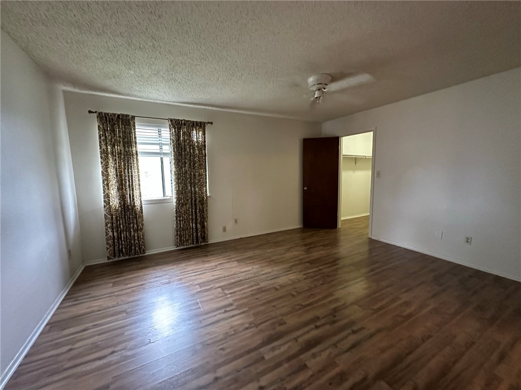 4229 Interstate Highway, Unit 4 Corpus Christi, TX 78410 - Photo 9 of 12 an empty room with wooden floor and windows