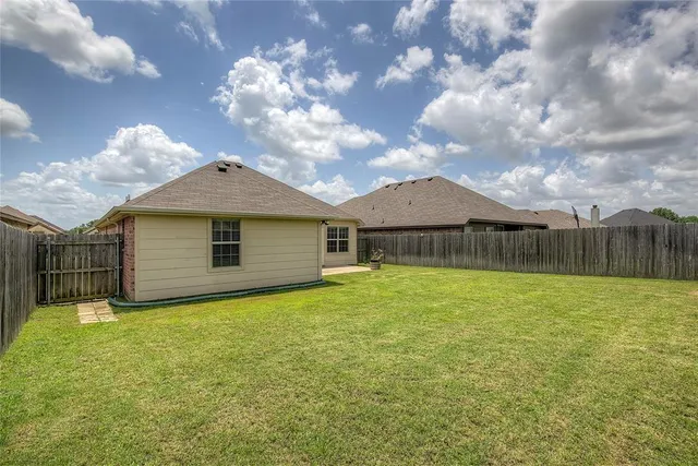 a view of a house with a yard and garage