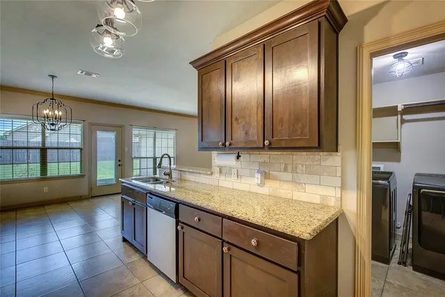 a kitchen with a sink and a refrigerator