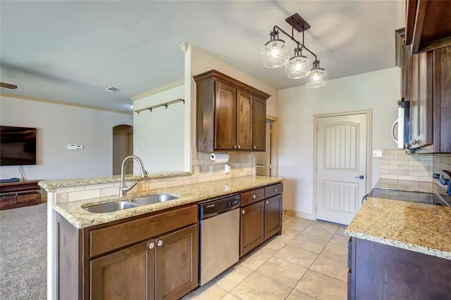 a spacious bathroom with a granite countertop sink and a mirror