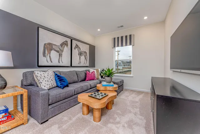 a living room with furniture and wall paintings