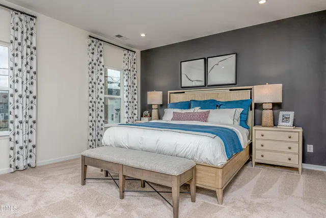 a bedroom with a bed and a mirror