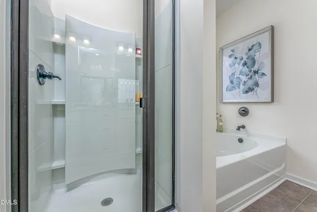 a bathroom with a bathtub and a shower