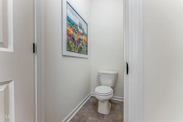 a white toilet sitting next to a shower