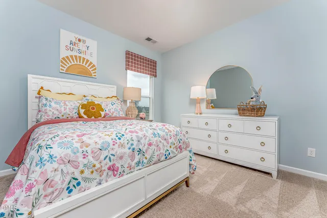 a bedroom with a bed and a dresser
