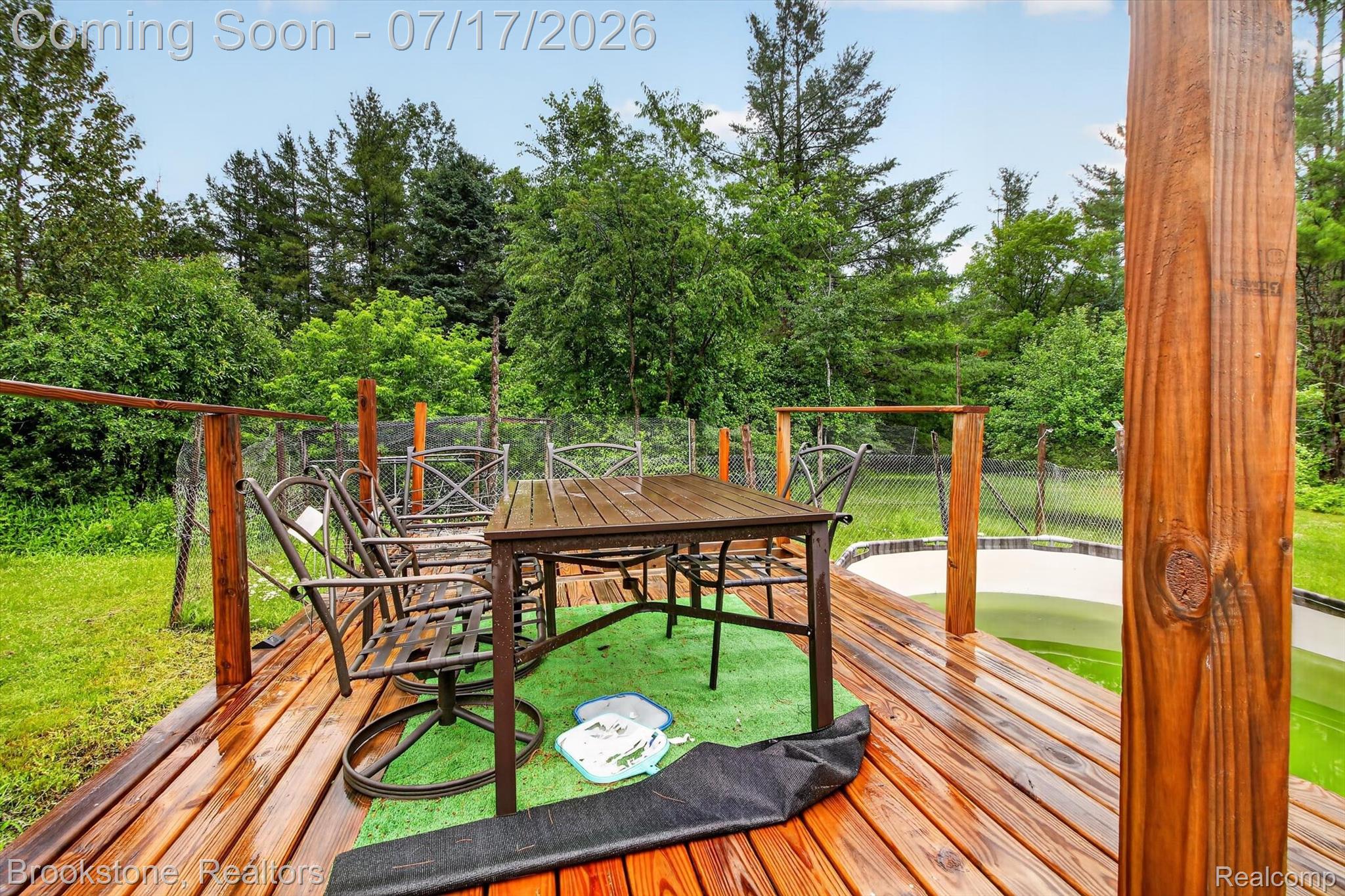 22709 Pleasant Valley Road Hillman, MI 49746 - Photo 29 of 42 Expansive wood deck featuring a clear finish, integrated fencing, and an adjacent built-in pool