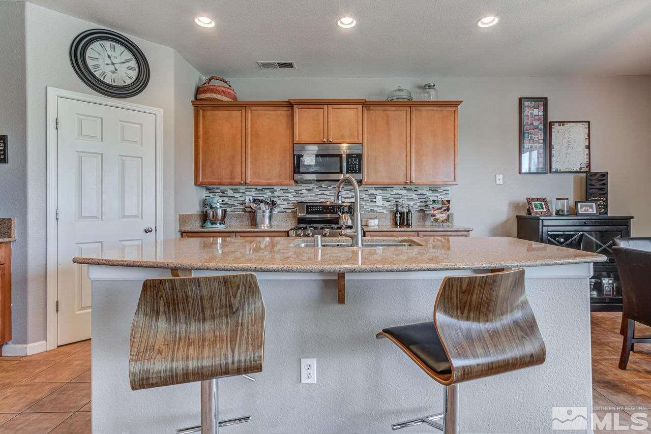 9275 Hummer Drive Reno, NV 89521 - Photo 12 of 33 a kitchen with a stove cabinets and a table