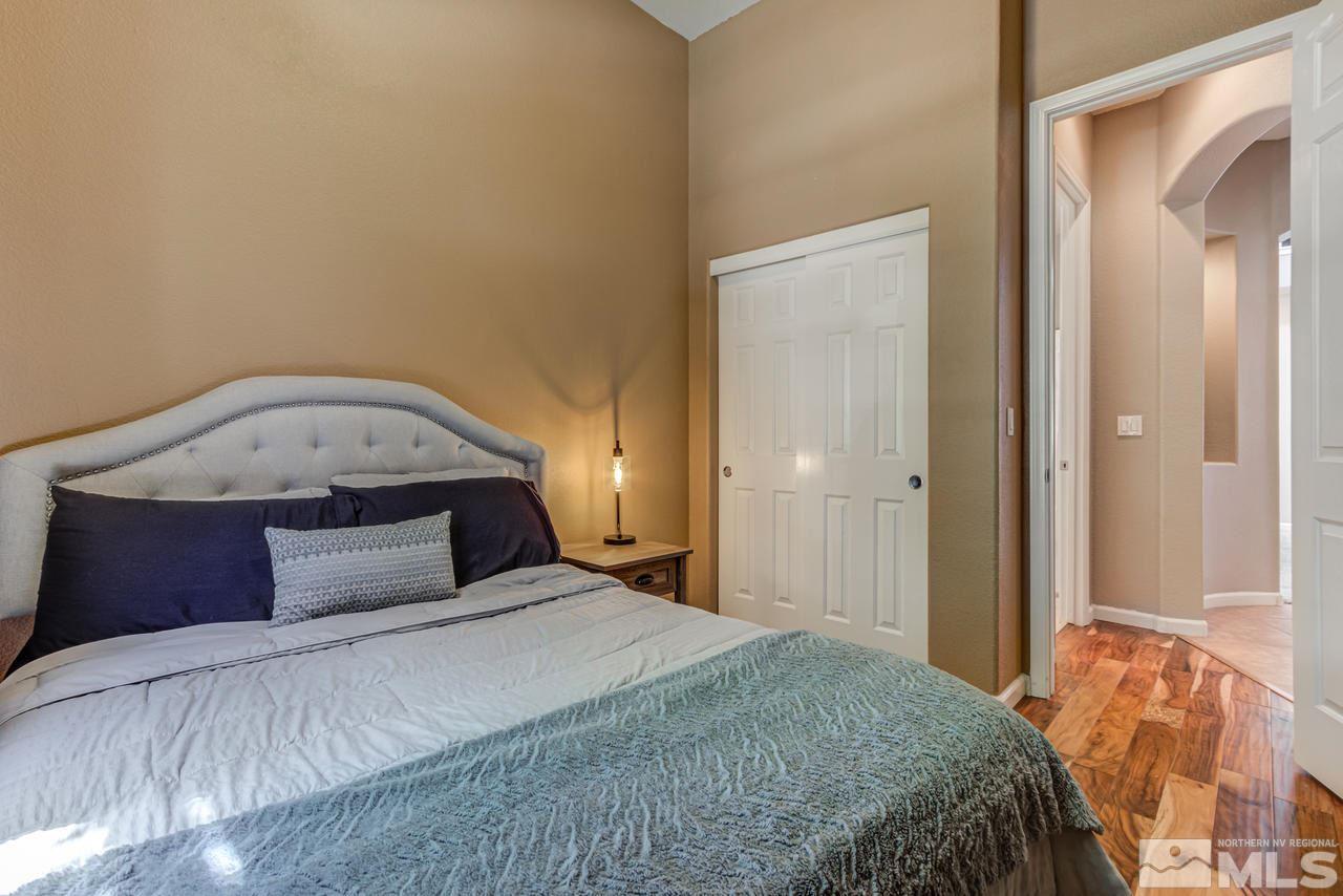 9275 Hummer Drive Reno, NV 89521 - Photo 17 of 33 a bedroom with a large bed and a chandelier