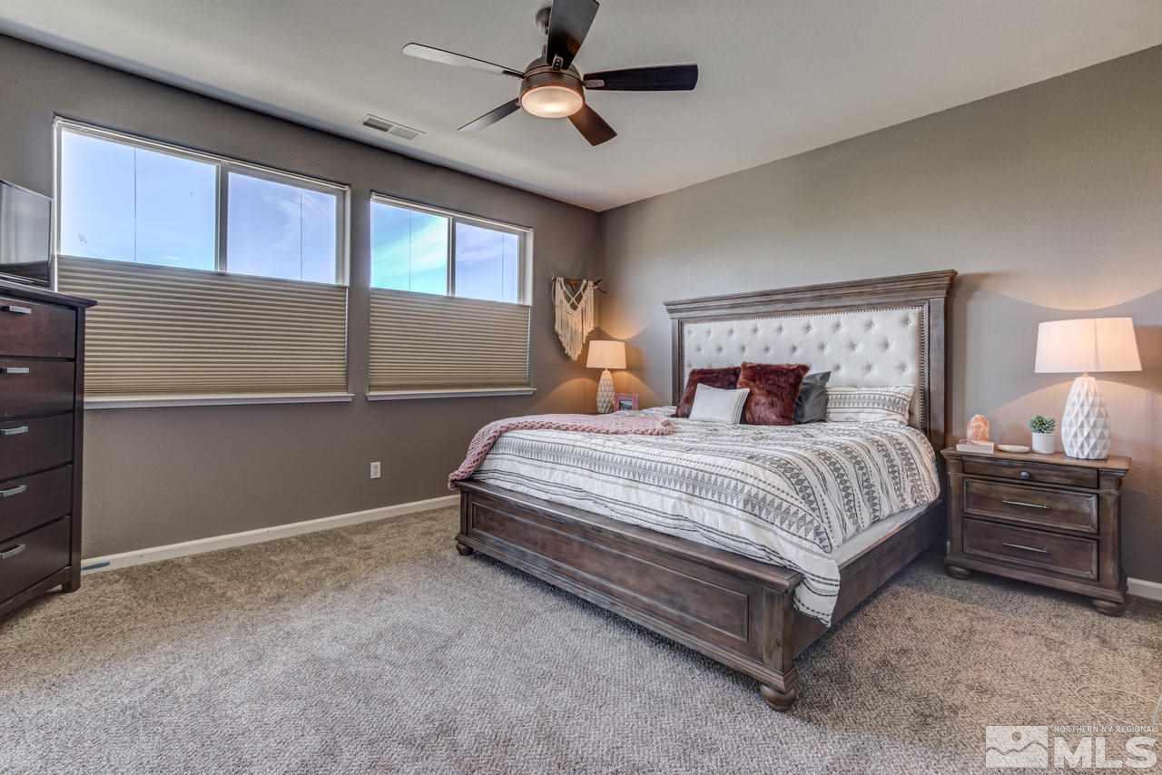 9275 Hummer Drive Reno, NV 89521 - Photo 22 of 33 a bedroom with a large bed and a chandelier