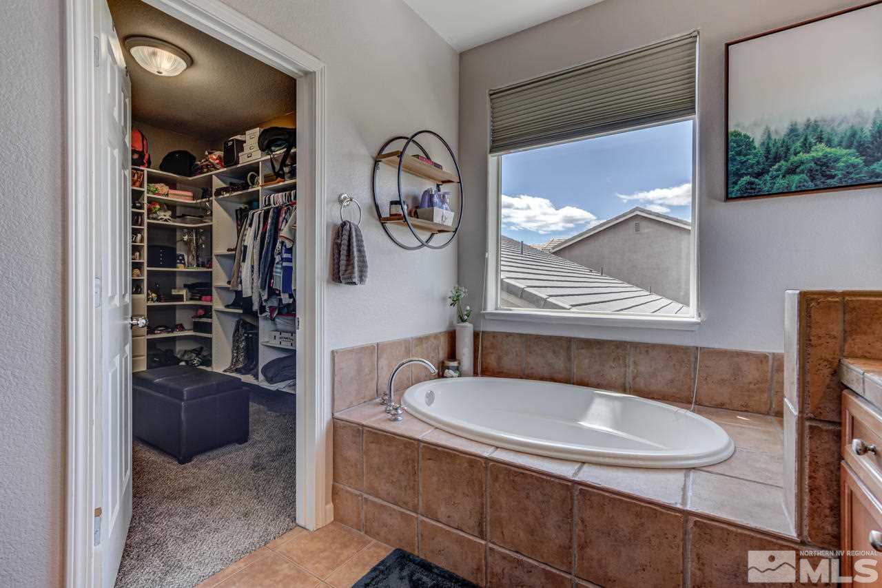 9275 Hummer Drive Reno, NV 89521 - Photo 26 of 33 a bathroom with a sink a mirror and a shower