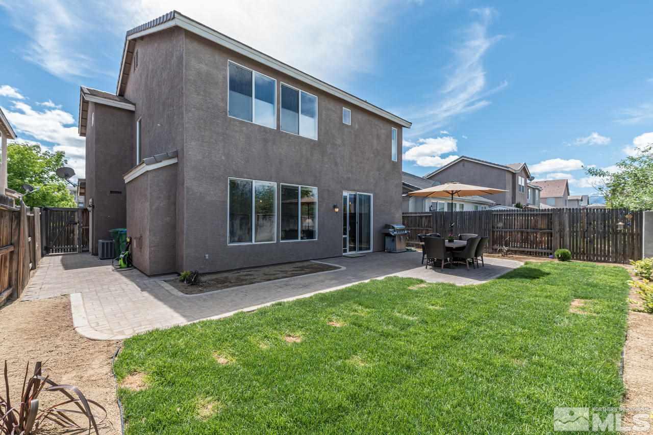 9275 Hummer Drive Reno, NV 89521 - Photo 32 of 33 a view of backyard with outdoor seating and wooden fence