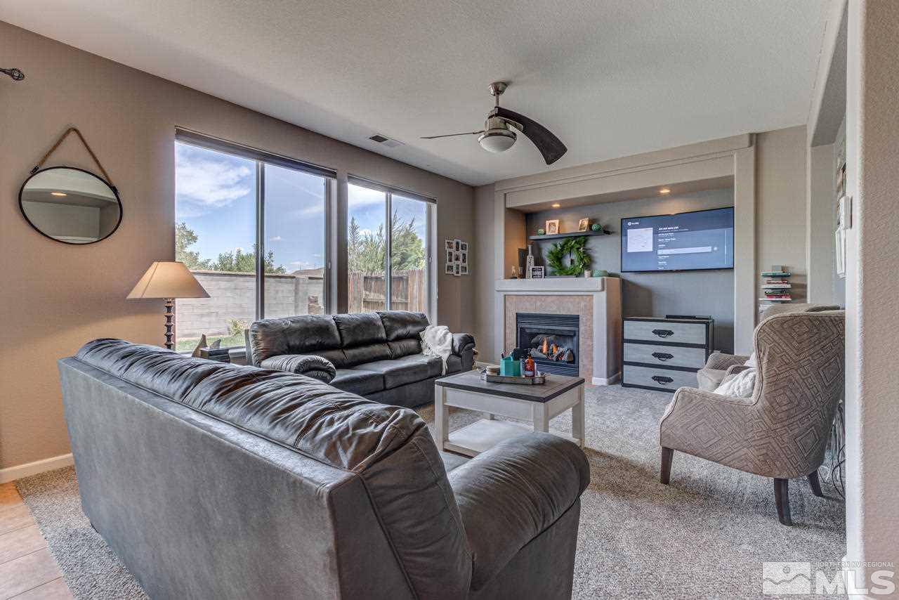 9275 Hummer Drive Reno, NV 89521 - Photo 6 of 33 a living room with furniture fireplace and flat screen tv