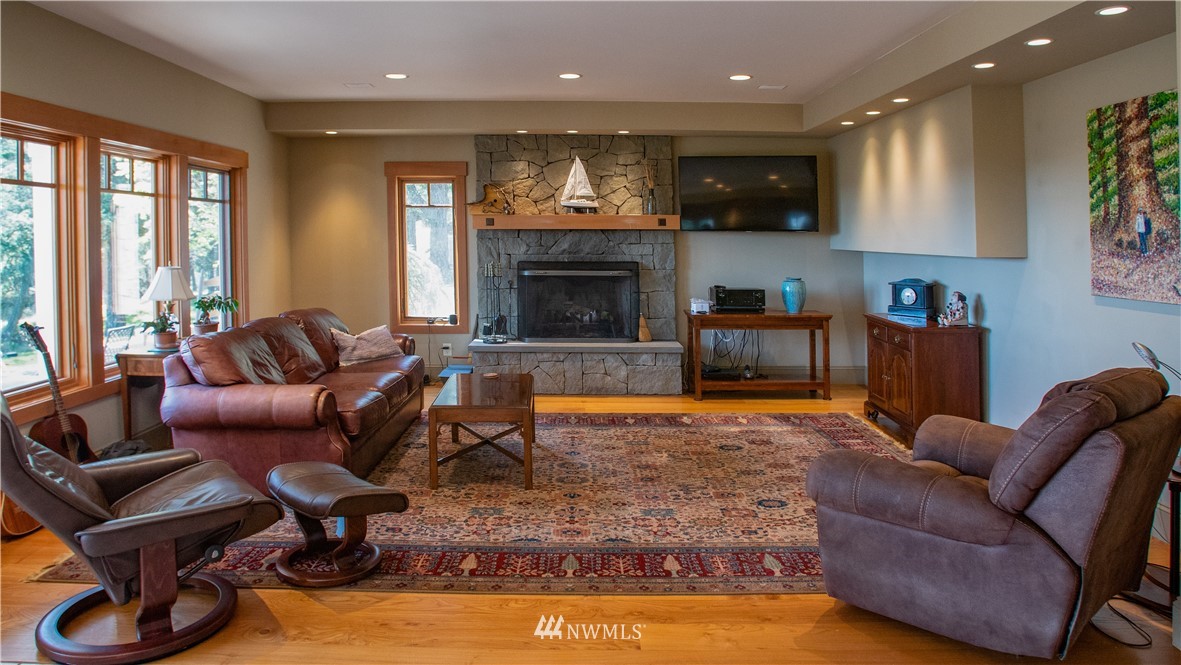400 Cormorant Bay Road Orcas Island, WA 98245 - Photo 16 of 39 a living room with furniture and a fireplace