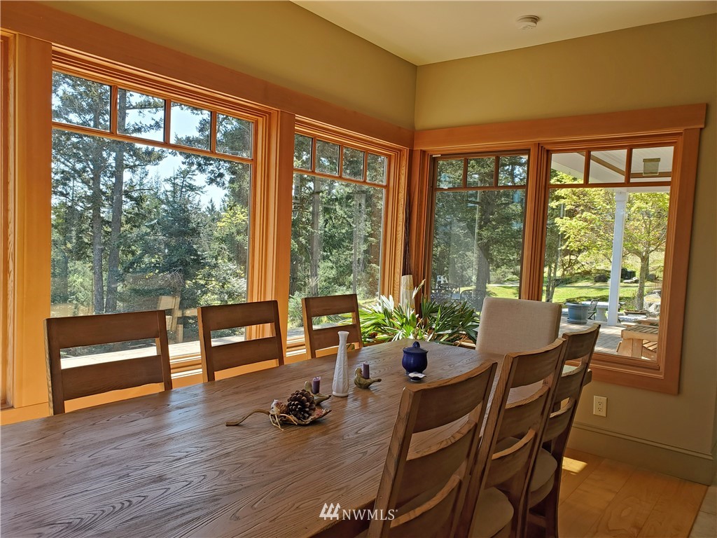 400 Cormorant Bay Road Orcas Island, WA 98245 - Photo 19 of 39 a dining room with furniture window and wooden floor