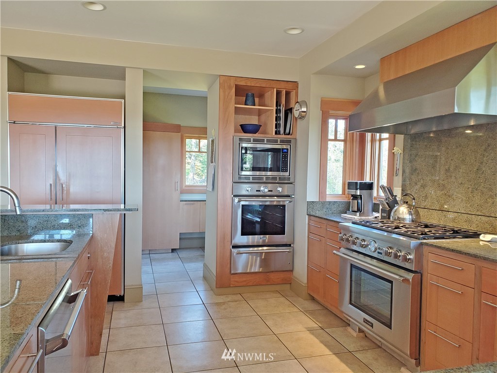 400 Cormorant Bay Road Orcas Island, WA 98245 - Photo 21 of 39 a kitchen with stainless steel appliances granite countertop a stove and a refrigerator