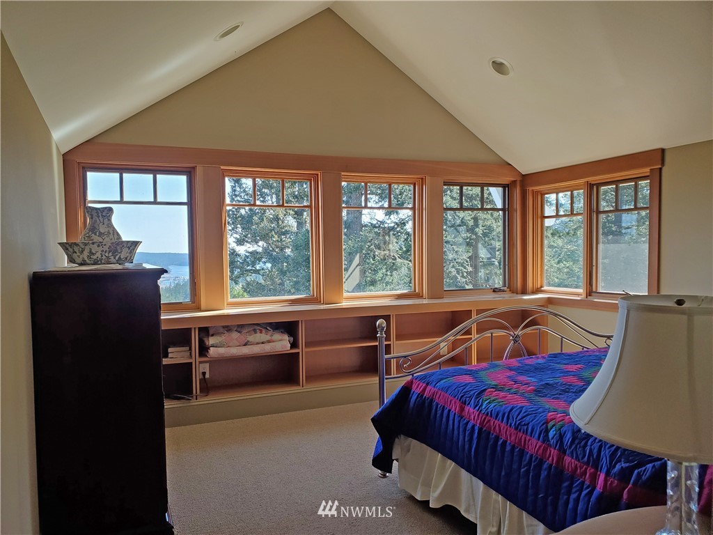 400 Cormorant Bay Road Orcas Island, WA 98245 - Photo 27 of 39 a bedroom with a bed and a large window
