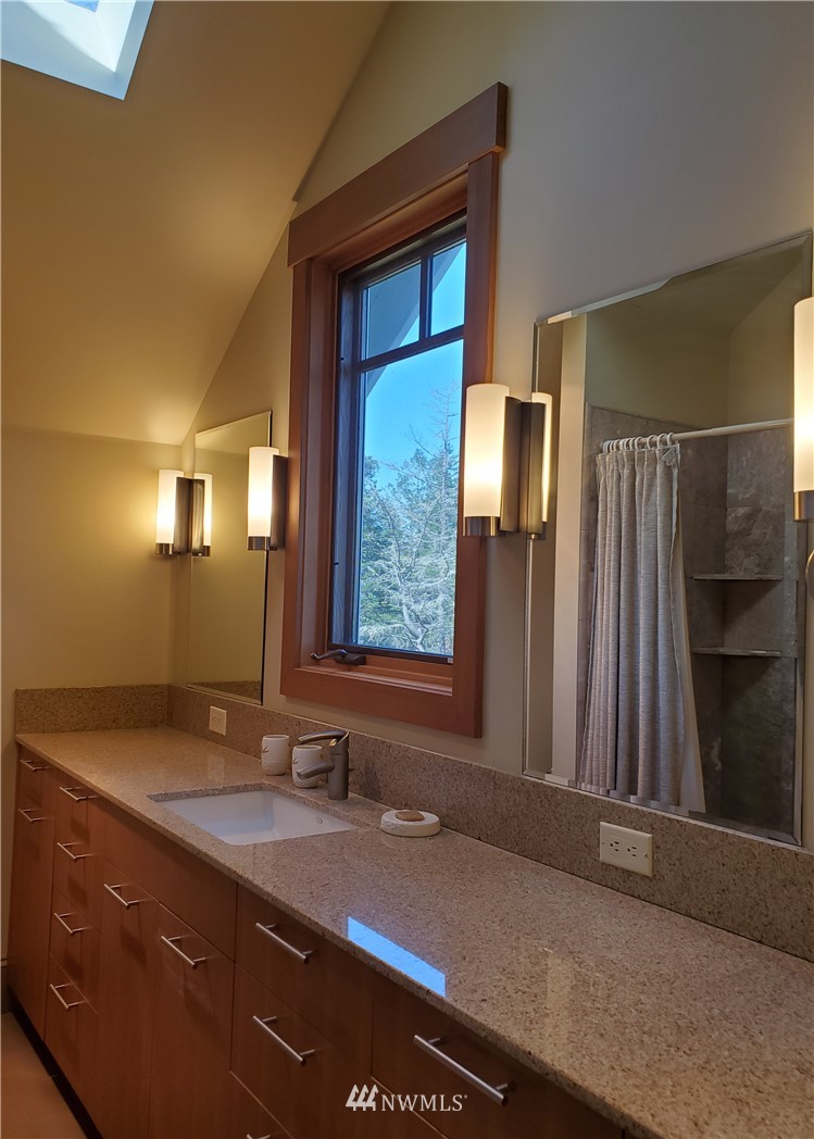 400 Cormorant Bay Road Orcas Island, WA 98245 - Photo 30 of 39 a bathroom with a granite countertop sink and a mirror