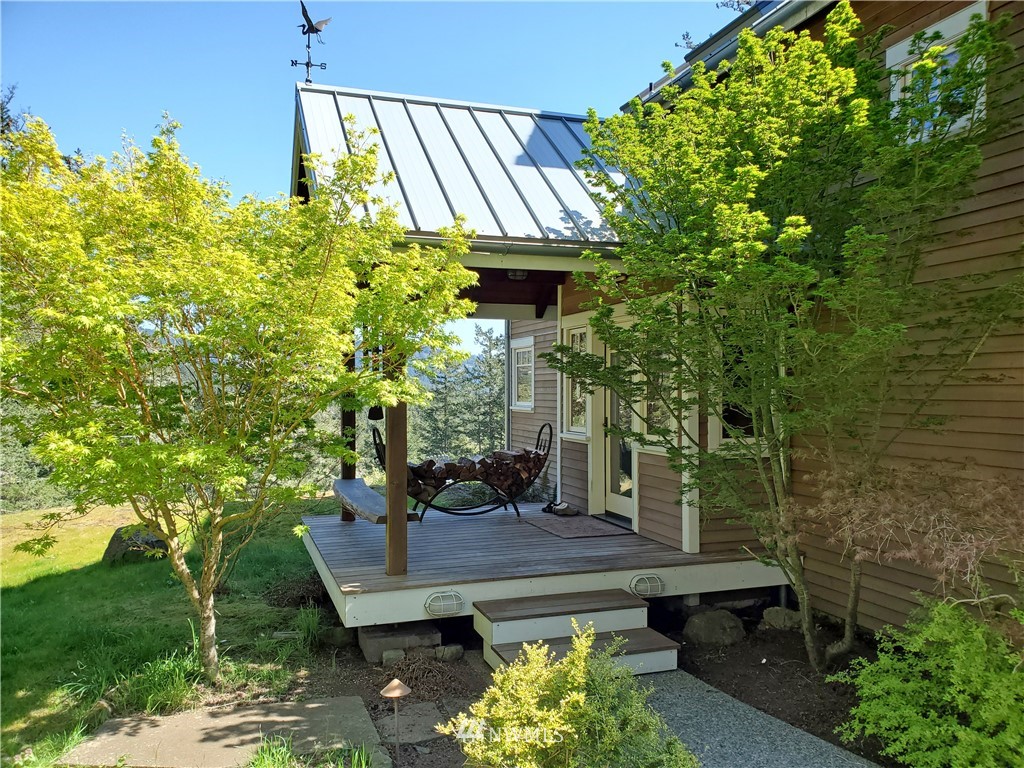 400 Cormorant Bay Road Orcas Island, WA 98245 - Photo 10 of 39 a view of a wooden bench sitting in backyard