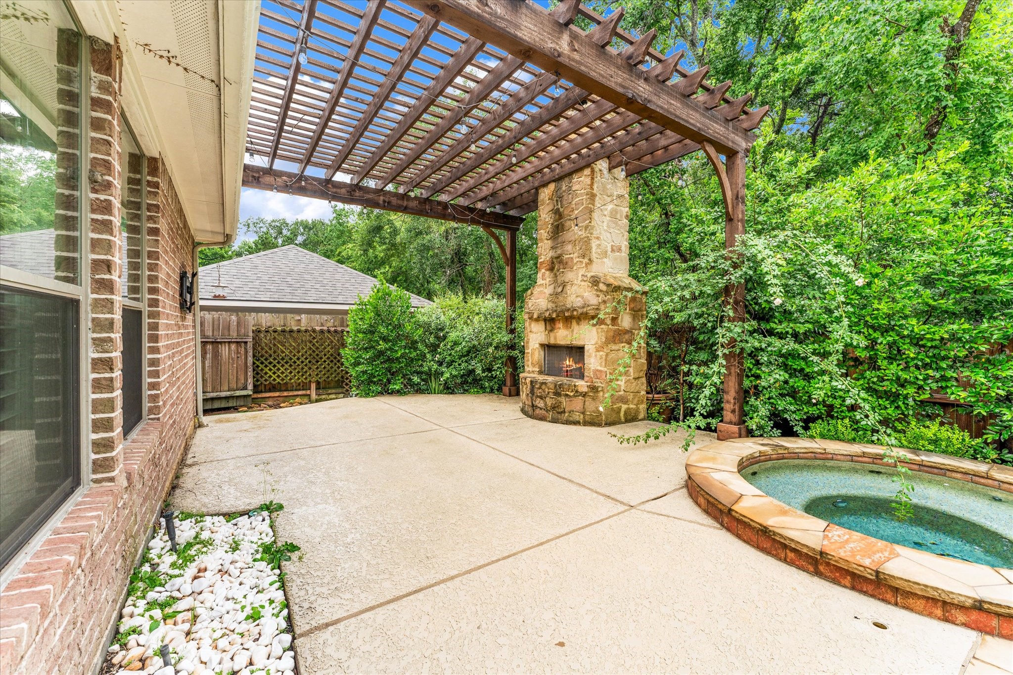 28331 Hollow Springs Lane Spring, TX 77386 - Photo 3 of 49 Backyard oasis featuring a swimming pool, spa, and a pergola with a wood-burning fireplace.