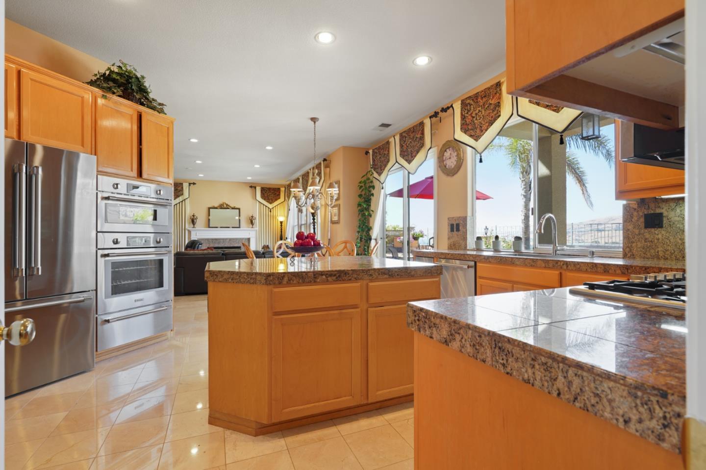 5793 Cannes Place San Jose, CA 95138 - Photo 5 of 29 a kitchen with stainless steel appliances granite countertop a sink and a refrigerator