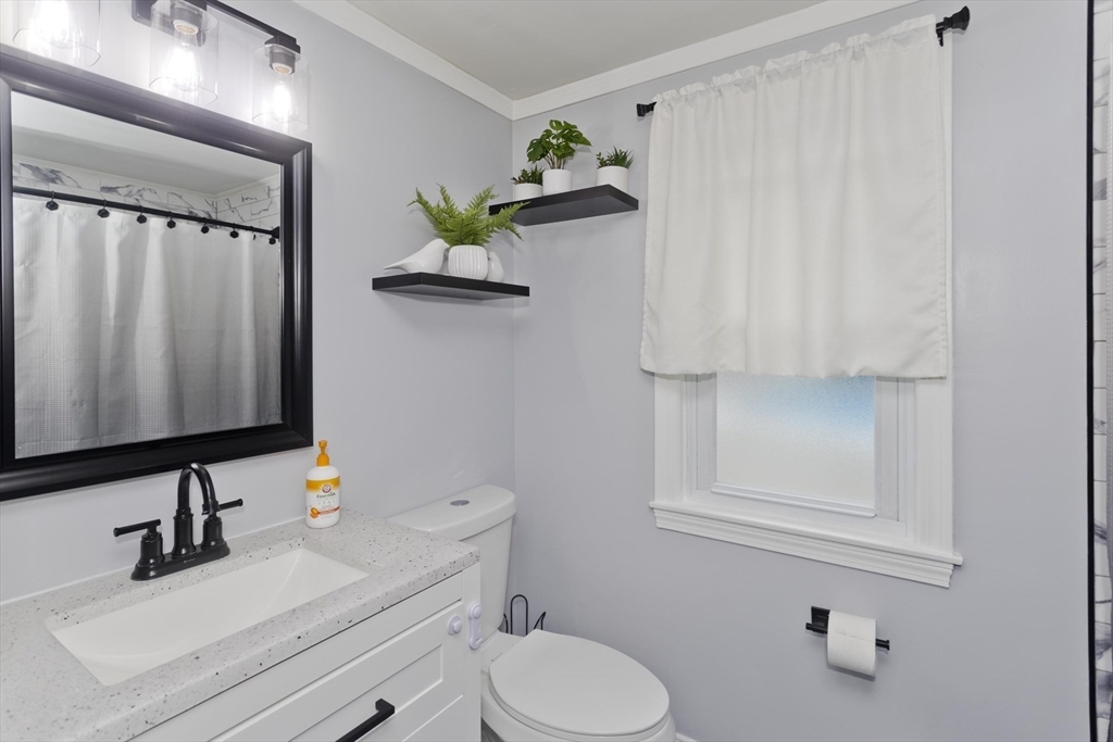 83 Chalmers Street Springfield, MA 01118 - Photo 17 of 40 a bathroom with a sink toilet and mirror