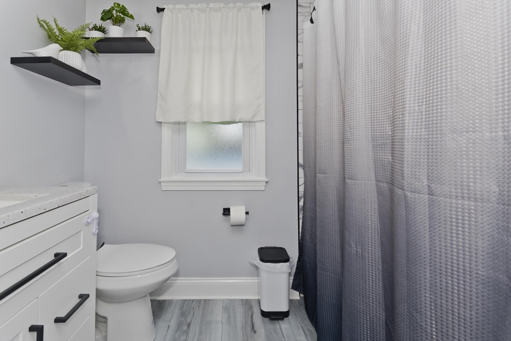 83 Chalmers Street Springfield, MA 01118 - Photo 18 of 40 a bathroom with a toilet and a shower curtain