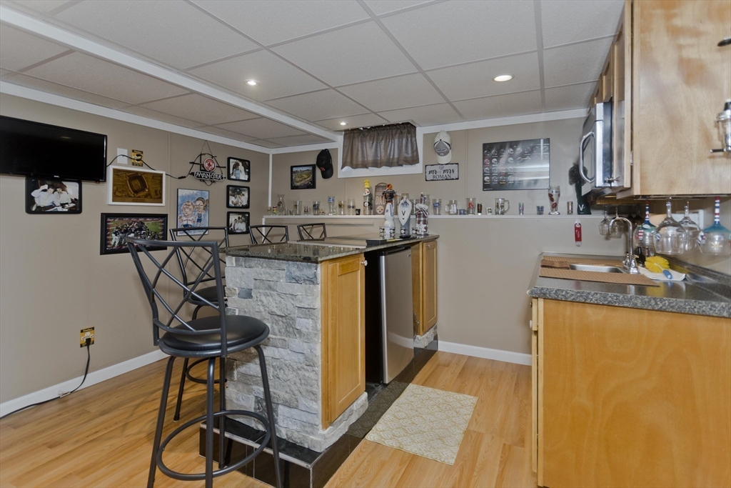 83 Chalmers Street Springfield, MA 01118 - Photo 23 of 40 a kitchen with stainless steel appliances granite countertop sink stove top oven and cabinets