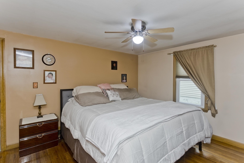 83 Chalmers Street Springfield, MA 01118 - Photo 29 of 40 a bedroom with a bed and a chandelier