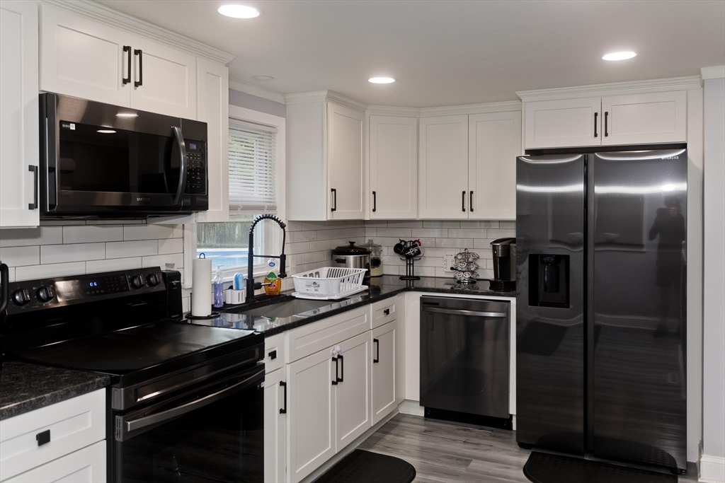 83 Chalmers Street Springfield, MA 01118 - Photo 3 of 40 a kitchen with a sink stainless steel appliances and cabinets