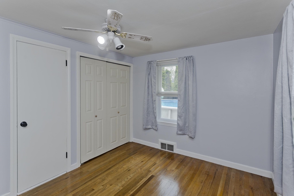 83 Chalmers Street Springfield, MA 01118 - Photo 32 of 40 a view of an empty room with window and wooden floor