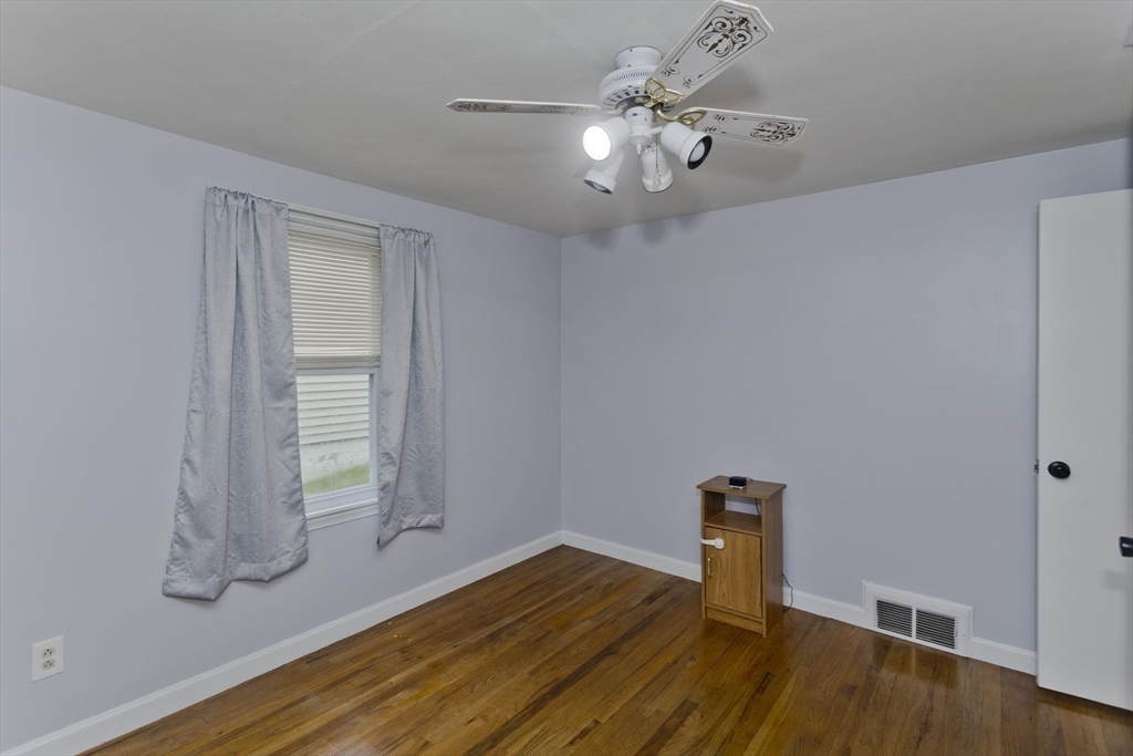 83 Chalmers Street Springfield, MA 01118 - Photo 34 of 40 wooden floor in an empty room with a window